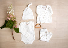 Load image into Gallery viewer, long sleeve body suit long sleeve wrap top kimono footed pants knotted hat  that goes in Organic Pima Cotton Baby gift box set bundle present baby shower hat kimono side snap top footed pants heart shaped natural wooden teether and Long Sleeve Bodysuit GOTS certified snap buttons handmade in Peru for Pan American Apparel in Ecowhite white and soft pink for newborn 0 to 3 months 3 to 6 months 6 to 9 months