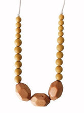 Load image into Gallery viewer, close up of The Austin Chewable silicone necklace in two colors tan brown mustard yellow with satin string for teething baby
