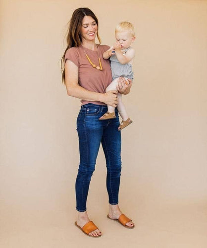 Mom and baby mom wearing The Austin Chewable silicone necklace in two colors tan brown mustard yellow with satin string for teething baby 
